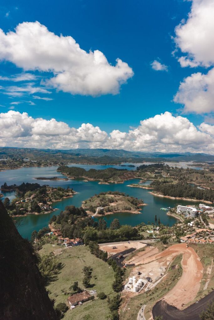 pexels photo 11358098 11358098 Stunning aerial view of Guatapé Lake in Colombia with vibrant blue sky and lush green islands.